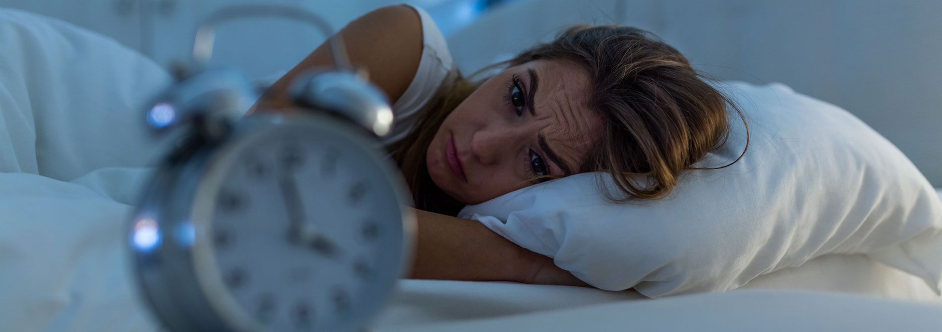 Woman in bed awake suffering from insomnia