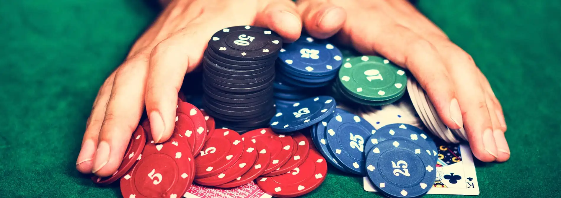 Hands holding poker chips.